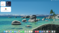 A macOS 26 desktop drawn in half-block characters: coarse, but its wallpaper, widgets and Dock are recognizable